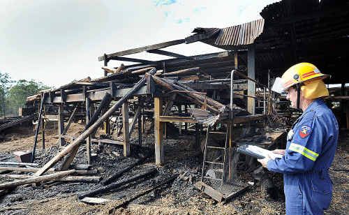 Torquay station officer Mark Long inspects the burnt out sawmill at Torbanlea Pine Timbers after fire ripped through early yesterday morning. Torquay station officer Mark Long inspects the burnt out sawmill at Torbanlea Pine Timbers after fire ripped through early yesterday morning.